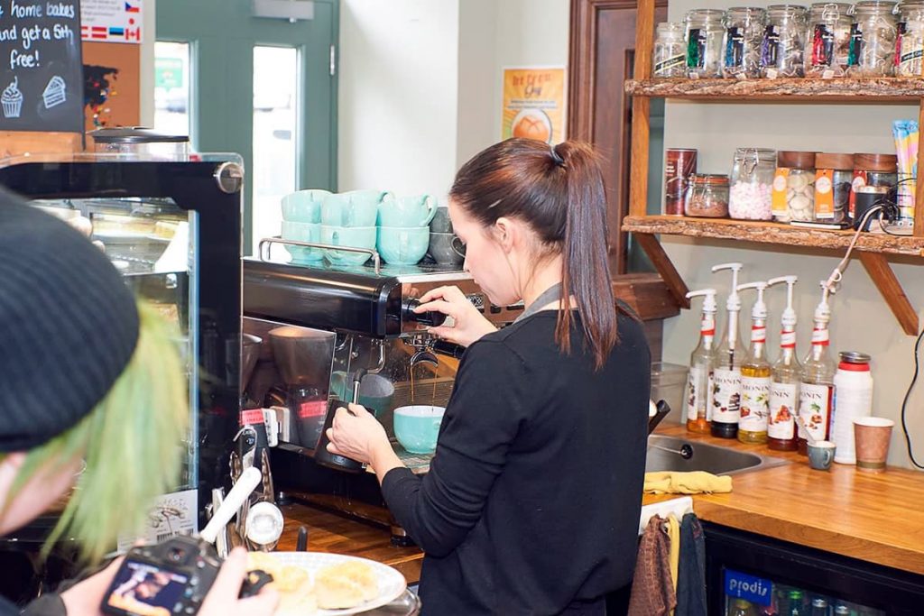 Woman making a coffee at Square Roots